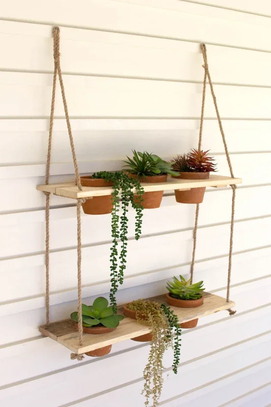 Two-tiered hanging wooden shelves with clay pots